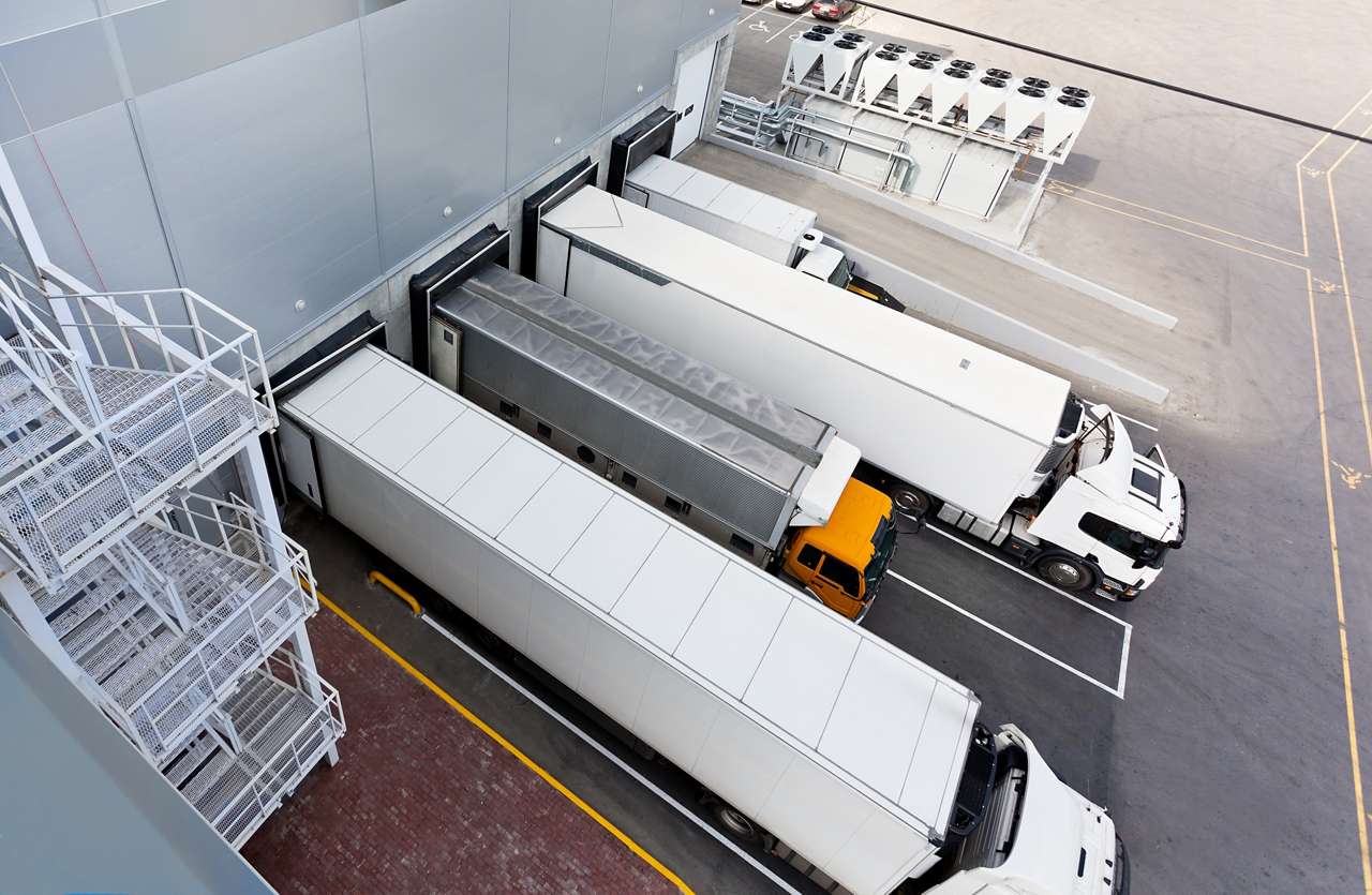 White trucks at loading dock White trucks at loading dock