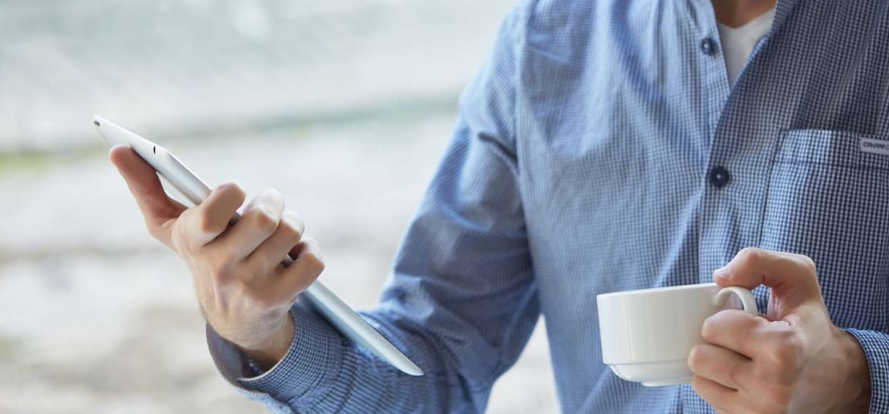 businessman with a cup of coffee and tablet
